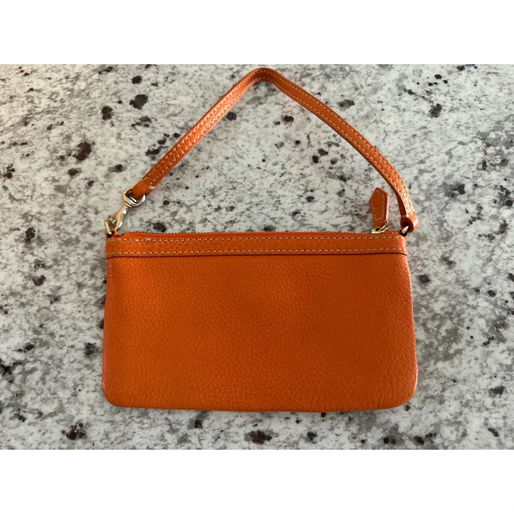 Dooney & Bourke pebble grain large slim wristlet bag in orange